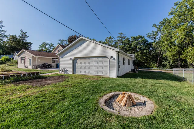 a swimming pool with outdoor seating and yard