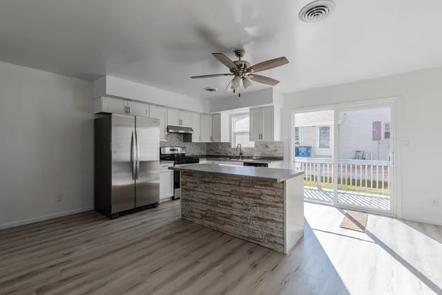 a kitchen with stainless steel appliances a refrigerator and a stove