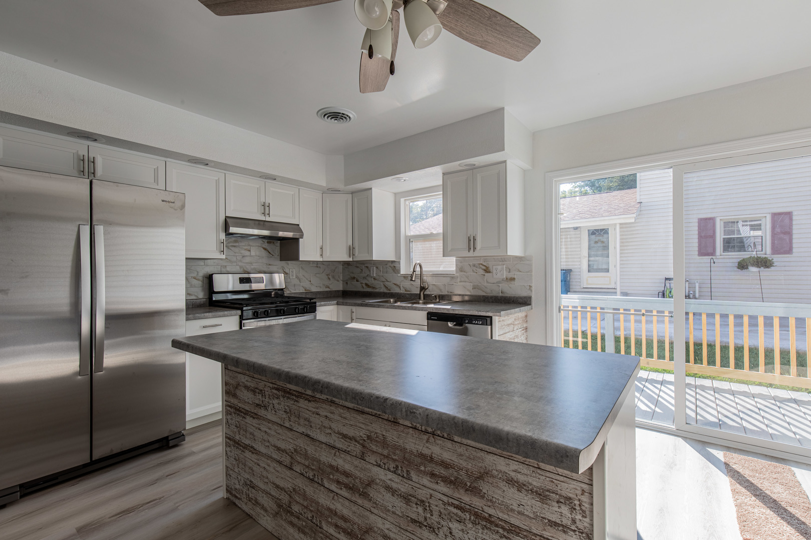 519 East Dakota Street Spring Valley, IL 61362 - Photo 7 of 23 a large kitchen with kitchen island a large counter space a sink stainless steel appliances and cabinets