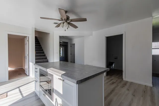 a view of kitchen island with cabinets and wooden floor