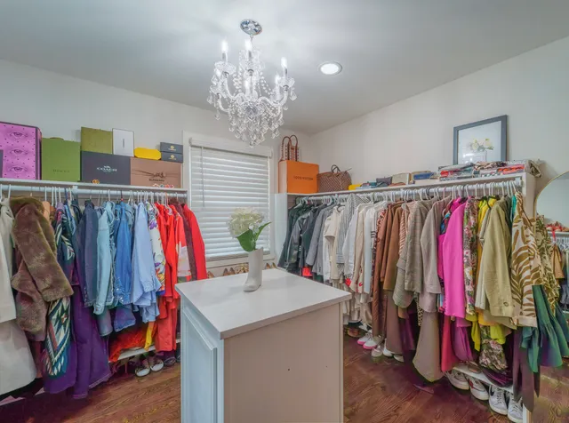 a view of walk in closet with clothes