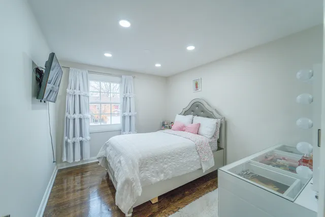 a bedroom with a bed and a dresser