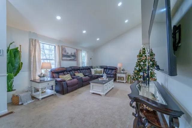 a living room with furniture a window and a flat screen tv