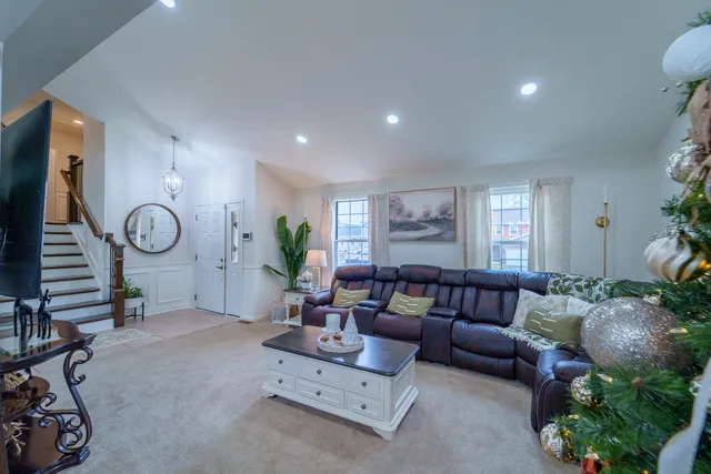 a living room with furniture a window and a potted plant