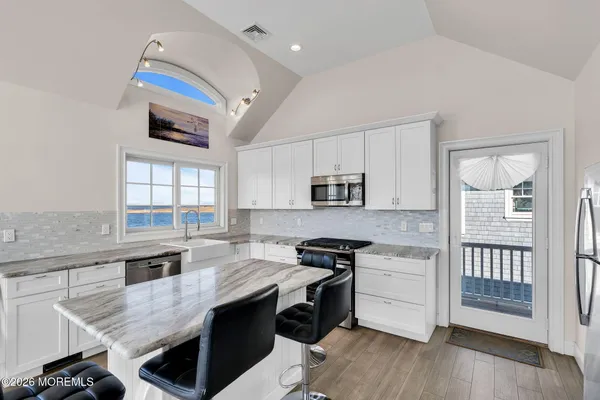 a kitchen with stainless steel appliances granite countertop a stove and a sink