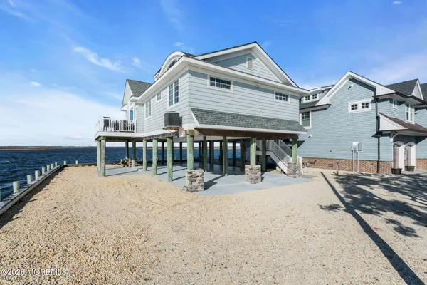 a view of a house with a wooden deck