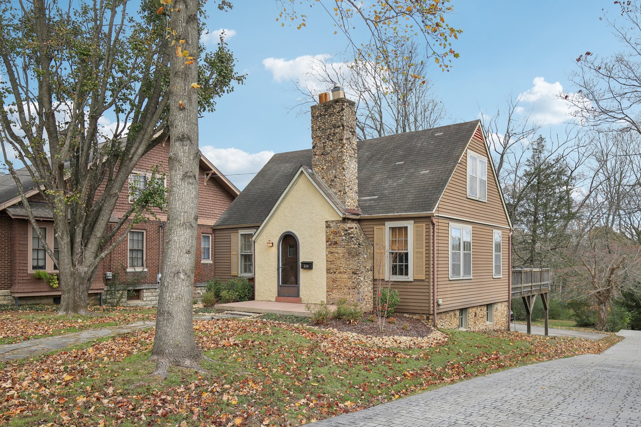 304 North Main Street Springfield, TN 37172 - Photo 3 of 60 a view of a white house next to a road with big trees