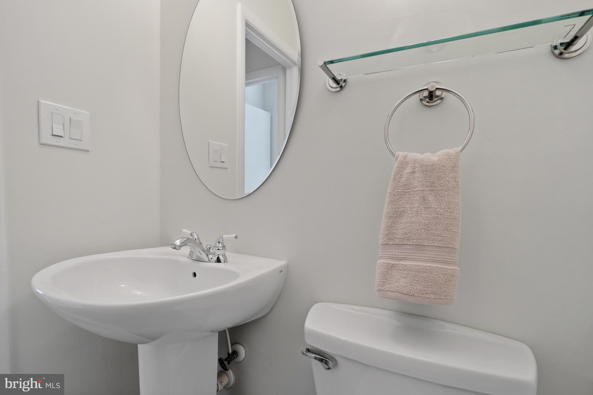 10908 Howland Drive Reston, VA 20191 - Photo 18 of 46 a bathroom with a sink a toilet and a mirror