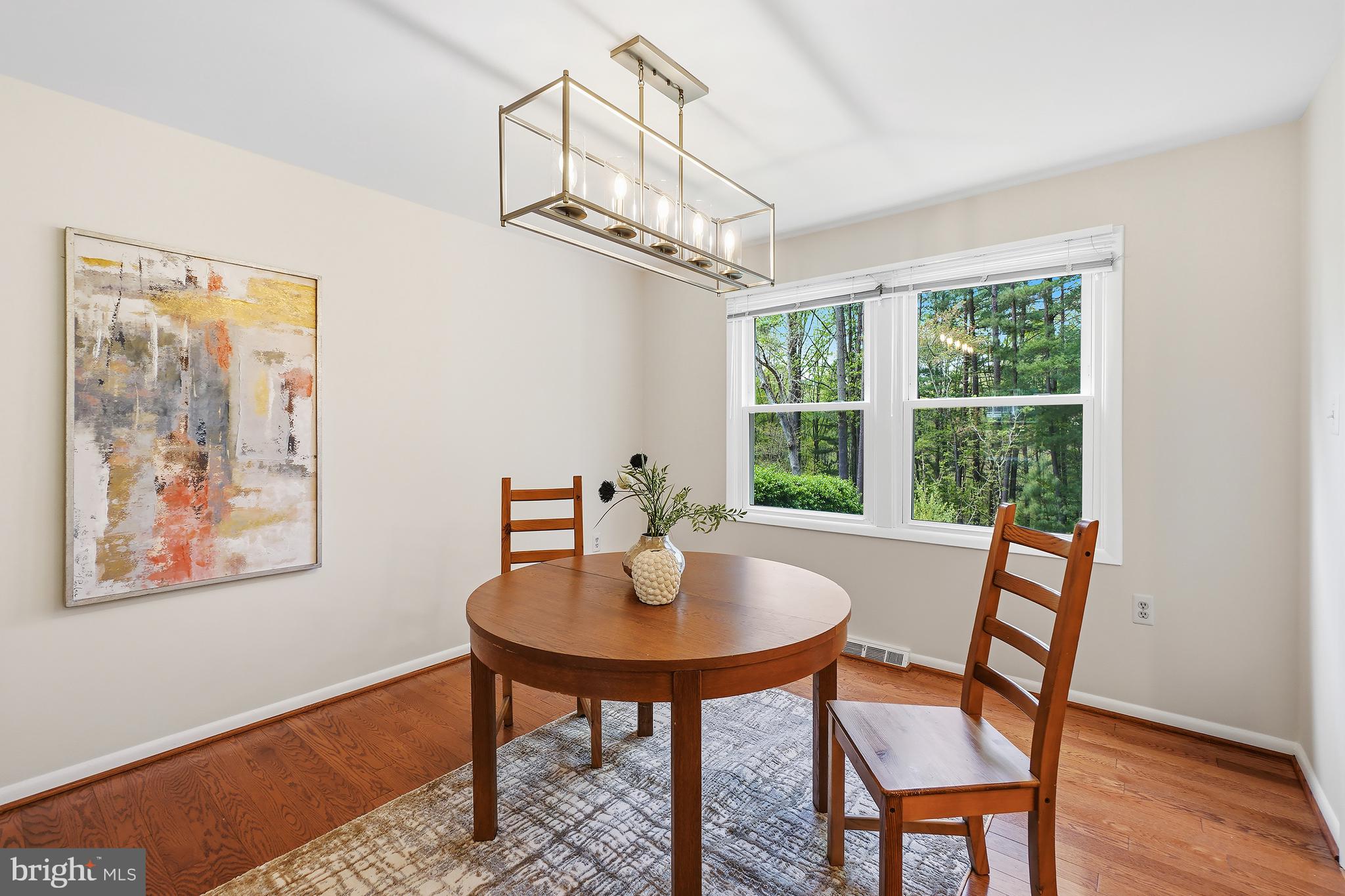 10908 Howland Drive Reston, VA 20191 - Photo 8 of 46 a dining room with furniture a chandelier and wooden floor