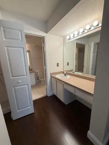 a bathroom with a sink a tub and a mirror