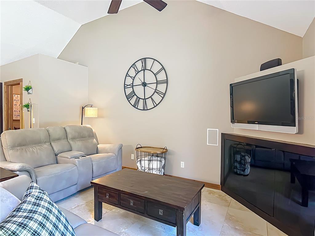 4661 Southwest 7th Avenue Road Ocala, FL 34471 - Photo 16 of 94 a living room with furniture and a flat screen tv