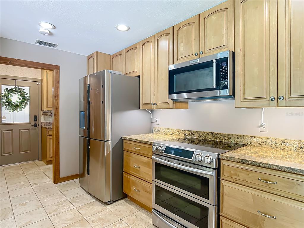 4661 Southwest 7th Avenue Road Ocala, FL 34471 - Photo 23 of 94 a kitchen with stainless steel appliances granite countertop a refrigerator stove and microwave