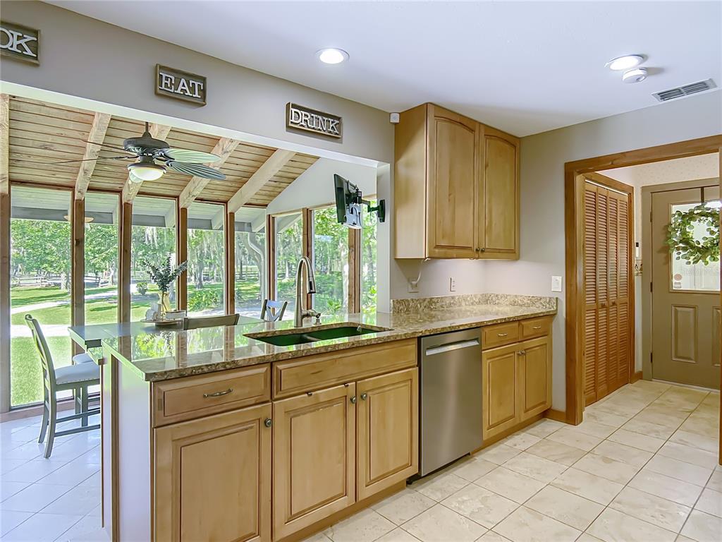 4661 Southwest 7th Avenue Road Ocala, FL 34471 - Photo 24 of 94 a kitchen with stainless steel appliances granite countertop a sink and cabinets