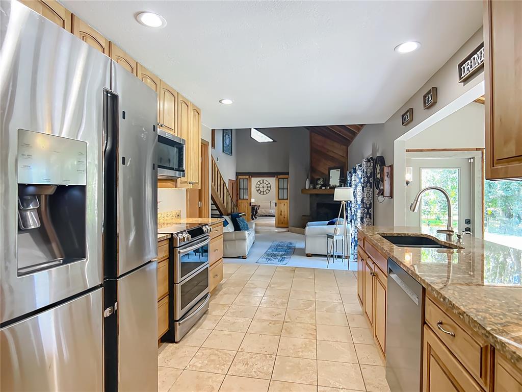 4661 Southwest 7th Avenue Road Ocala, FL 34471 - Photo 25 of 94 a large kitchen with stainless steel appliances granite countertop a refrigerator and a stove