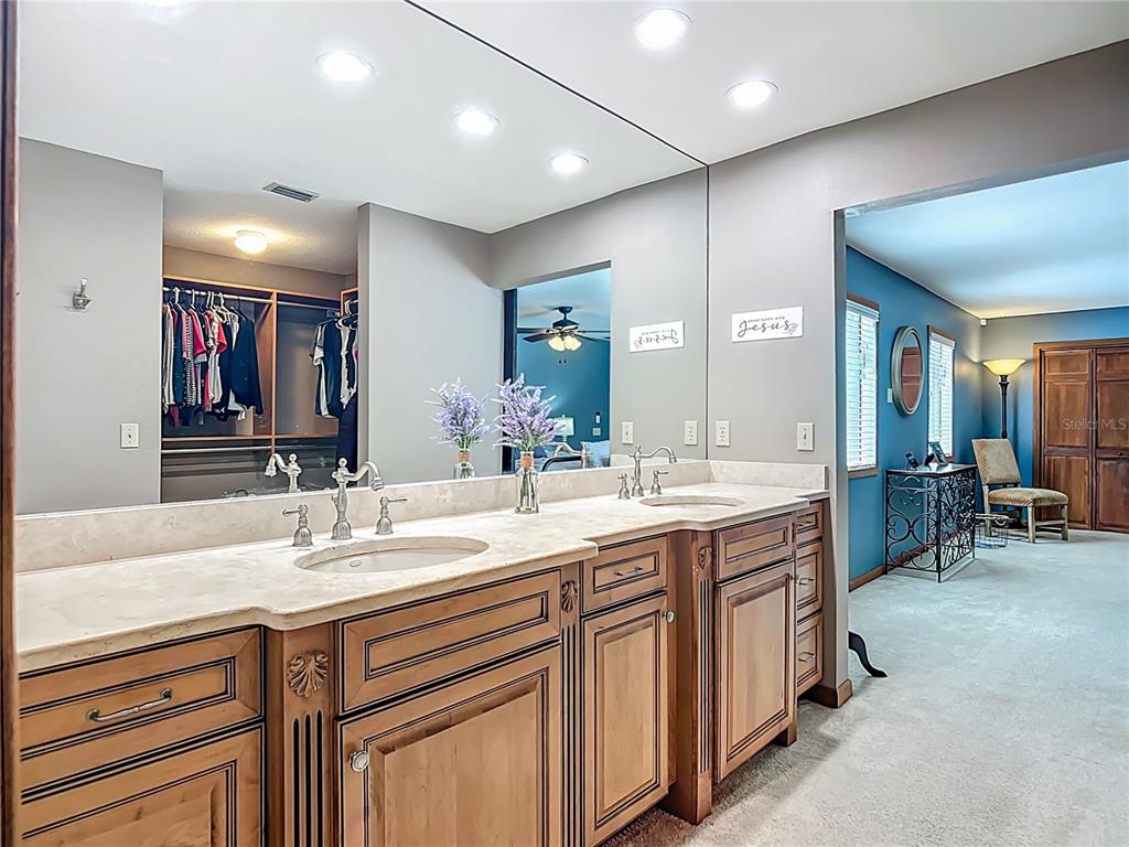 4661 Southwest 7th Avenue Road Ocala, FL 34471 - Photo 38 of 94 a spacious bathroom with a double vanity sink and a mirror