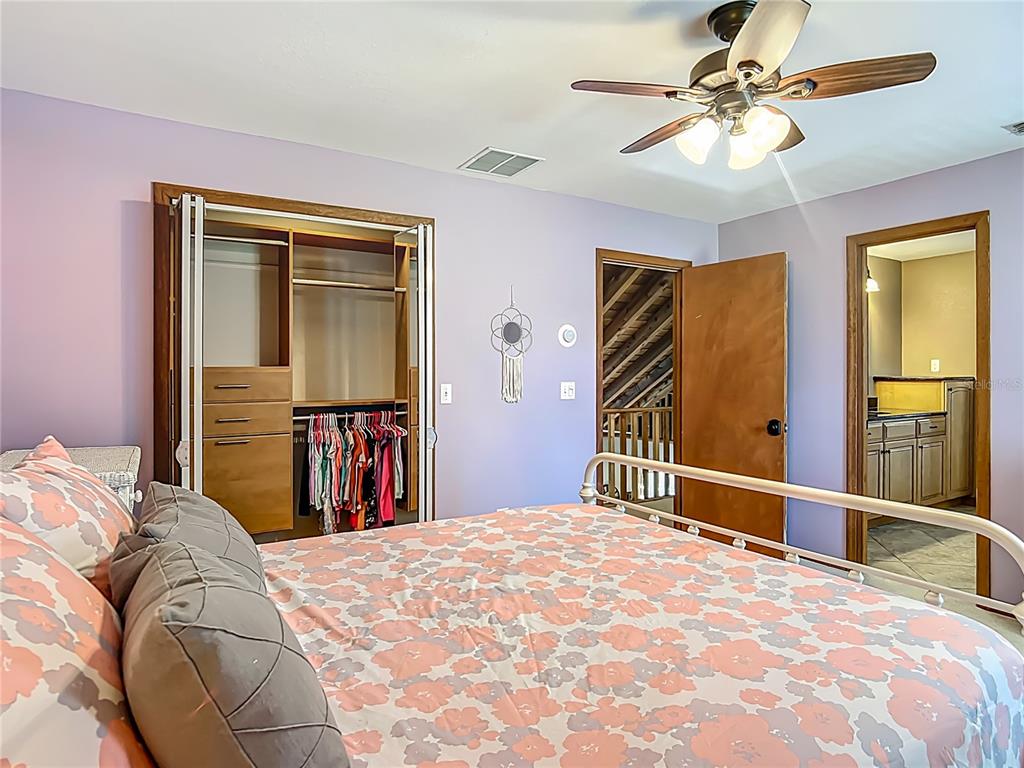 4661 Southwest 7th Avenue Road Ocala, FL 34471 - Photo 51 of 94 a bedroom with a large bed and a chandelier