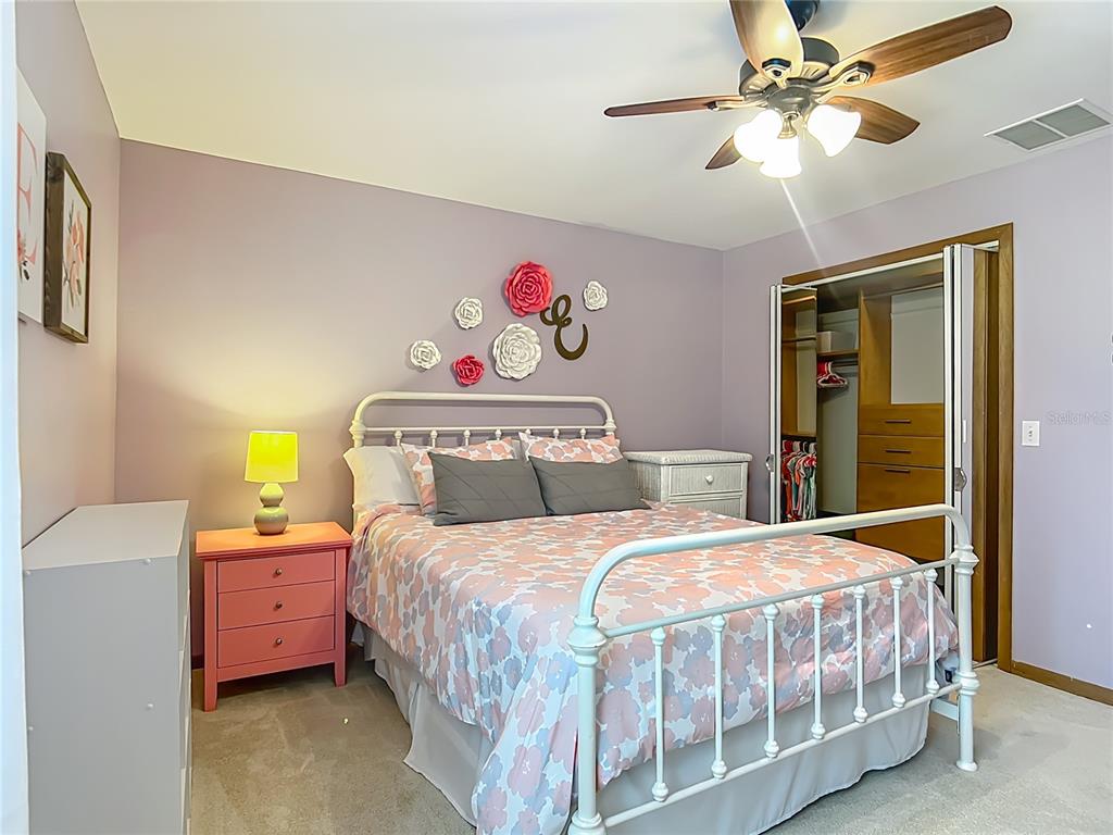 4661 Southwest 7th Avenue Road Ocala, FL 34471 - Photo 52 of 94 a bedroom with a bed and a chandelier