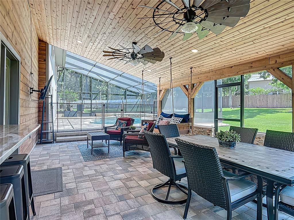 4661 Southwest 7th Avenue Road Ocala, FL 34471 - Photo 61 of 94 a view of a patio with a table chairs and a small yard