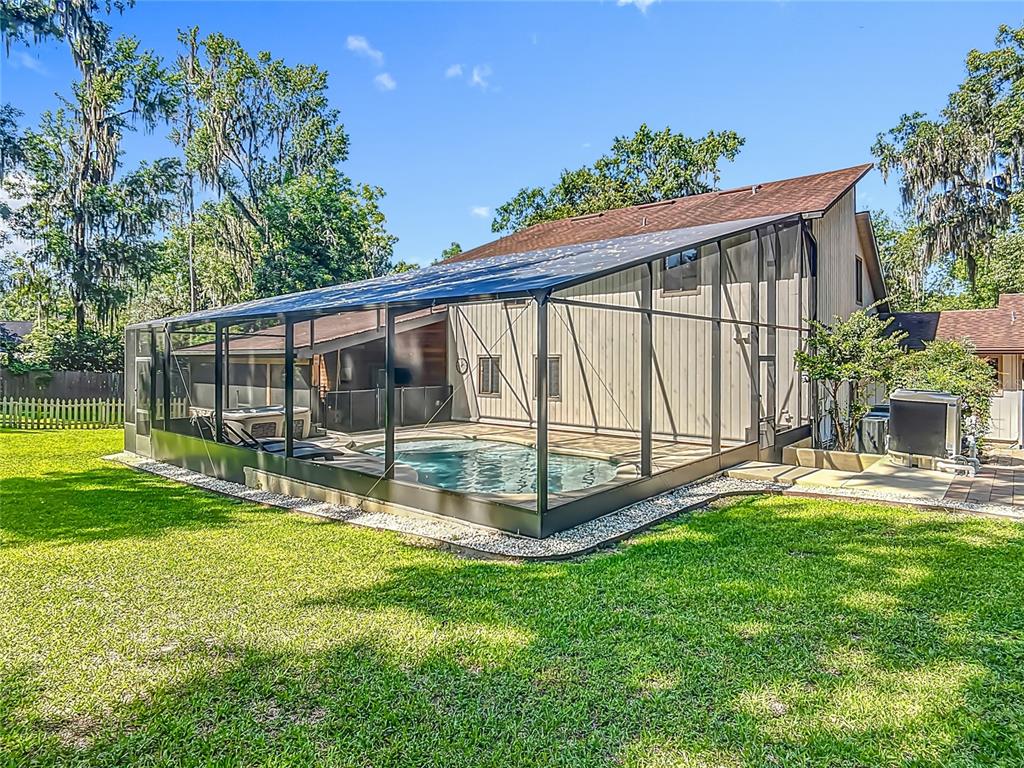 4661 Southwest 7th Avenue Road Ocala, FL 34471 - Photo 73 of 94 a view of a backyard with a garden and deck