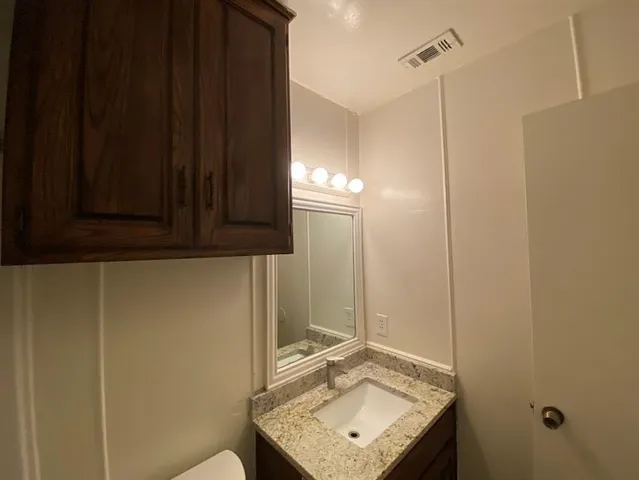 a bathroom with a sink a mirror and shower
