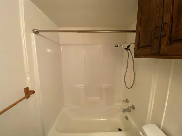 a bathroom with a shower and a shower