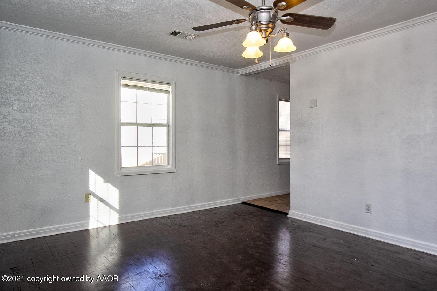 4431 Bowie Street Amarillo, TX 79110 - Photo 2 of 13 wooden floor in an empty room with a window