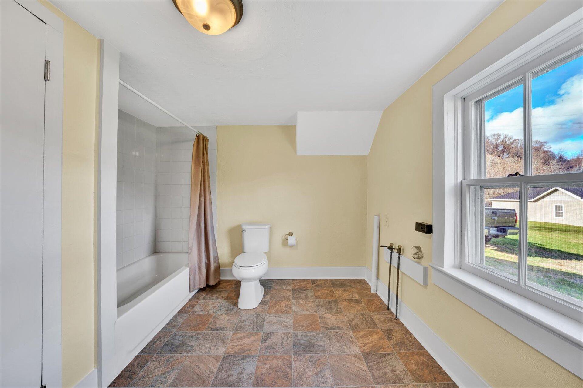 5206 Riner Road Riner, VA 24149 - Photo 17 of 31 a bathroom with a toilet a sink and a shower