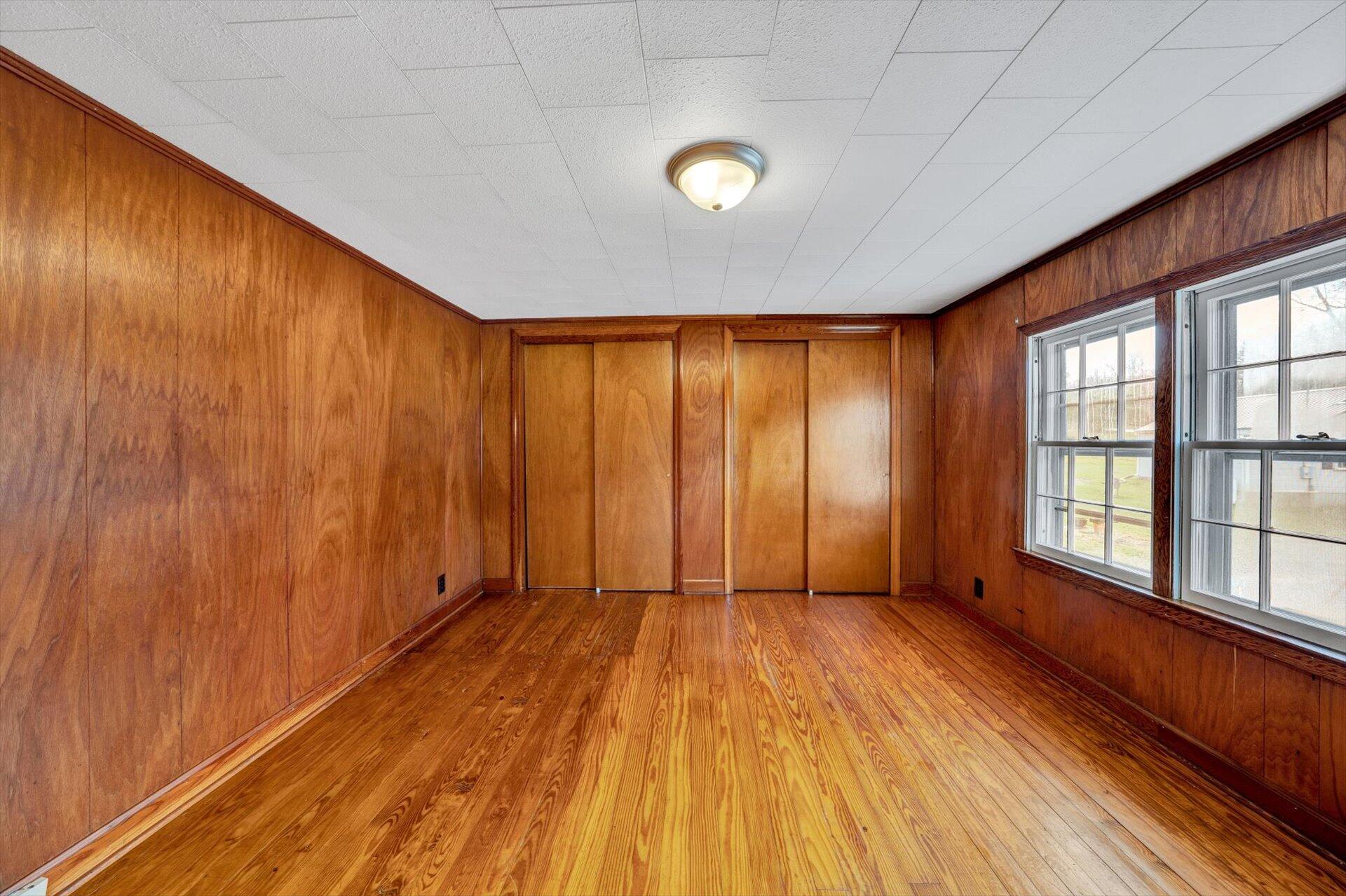 5206 Riner Road Riner, VA 24149 - Photo 23 of 31 a view of an empty room with wooden floor and a window