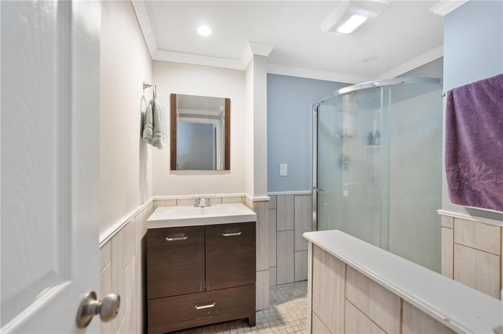 2630 Mt Royal Road Pittsburgh, PA 15217 - Photo 11 of 21 a bathroom with a double vanity sink mirror and shower