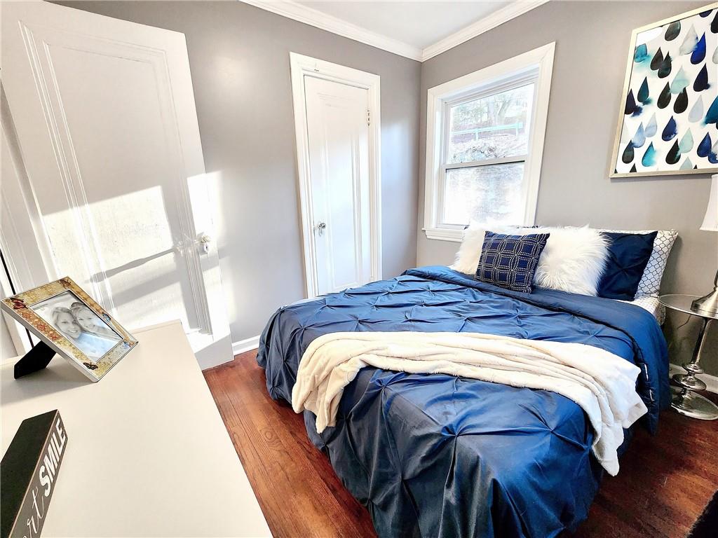 2630 Mt Royal Road Pittsburgh, PA 15217 - Photo 12 of 21 a bedroom with a bed and wooden floor