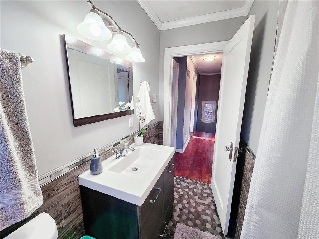 2630 Mt Royal Road Pittsburgh, PA 15217 - Photo 16 of 21 a bathroom with a sink vanity and a mirror