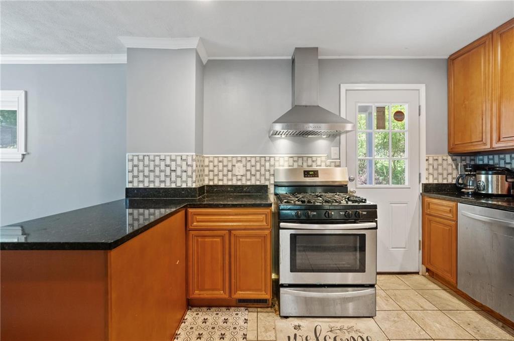2630 Mt Royal Road Pittsburgh, PA 15217 - Photo 9 of 21 a kitchen with granite countertop a stove top oven cabinetry and a refrigerator