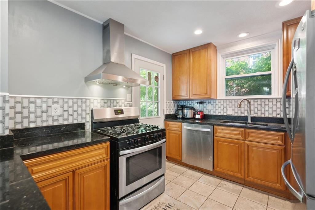 2630 Mt Royal Road Pittsburgh, PA 15217 - Photo 10 of 21 a kitchen with granite countertop a stove sink and cabinets