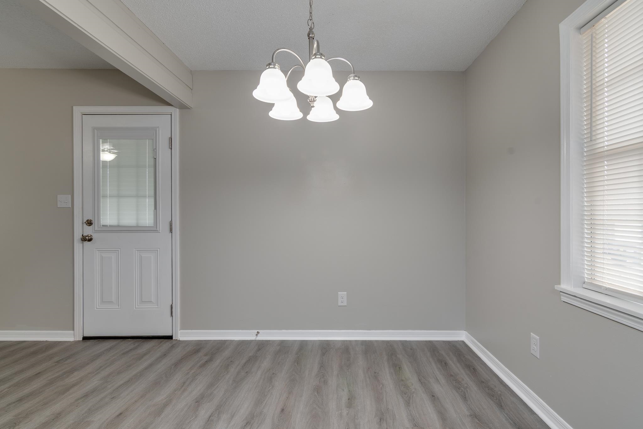 282 Volz Road Ripley, TN 38063 - Photo 4 of 25 wooden floor in an empty room with a window