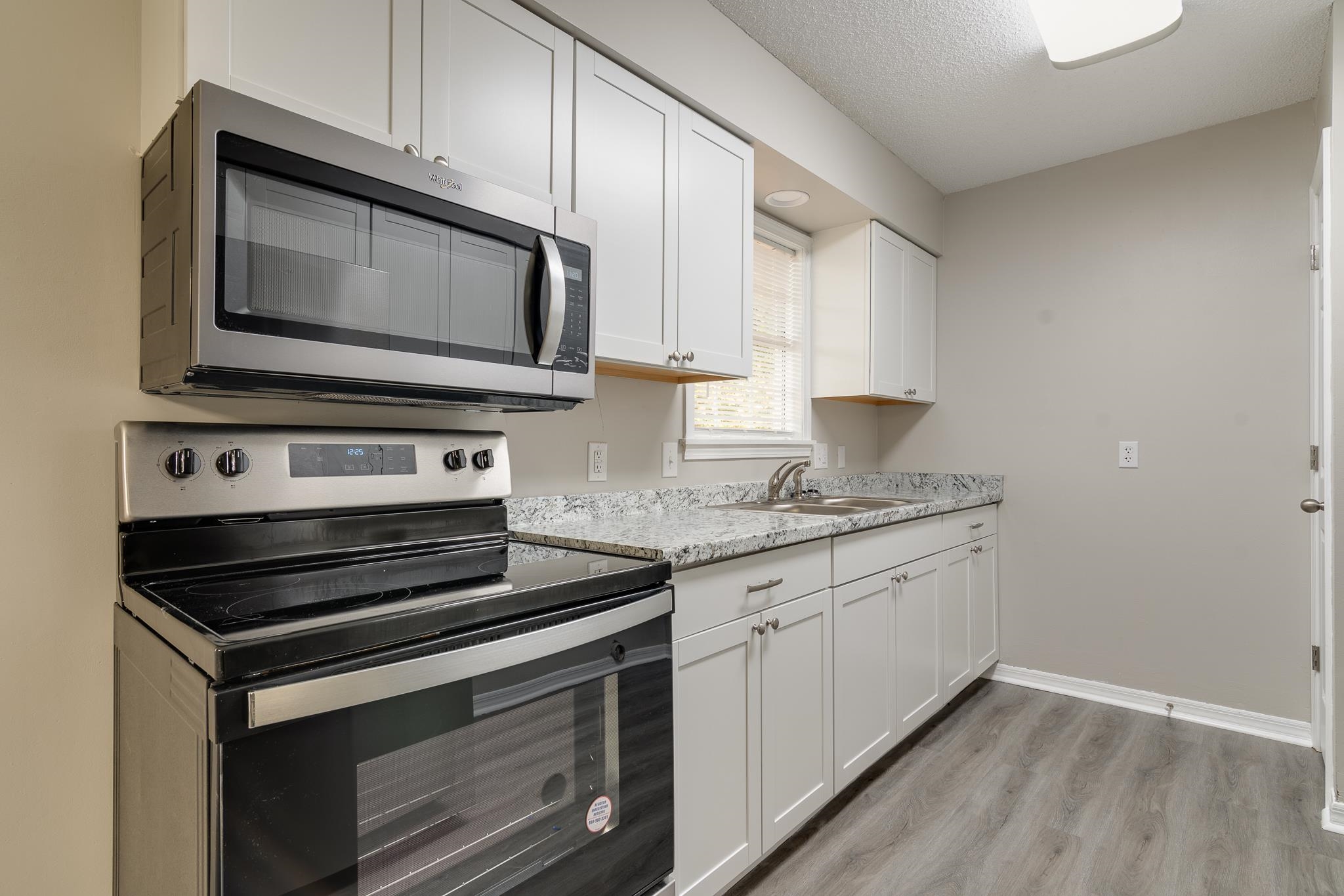 282 Volz Road Ripley, TN 38063 - Photo 5 of 25 a kitchen with granite countertop a stove microwave and sink