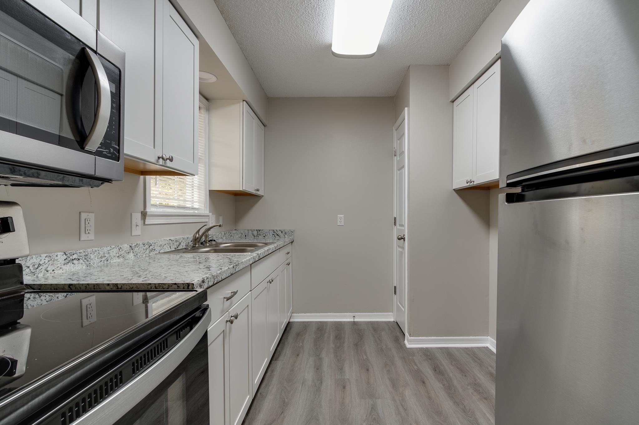 282 Volz Road Ripley, TN 38063 - Photo 6 of 25 a kitchen with a sink stove and refrigerator