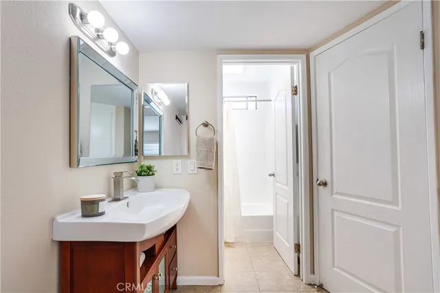 a bathroom with a sink a mirror and a shower