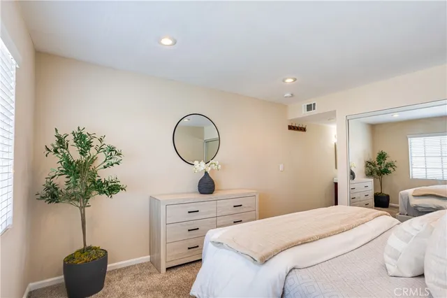 a living room with furniture potted plant and glass door