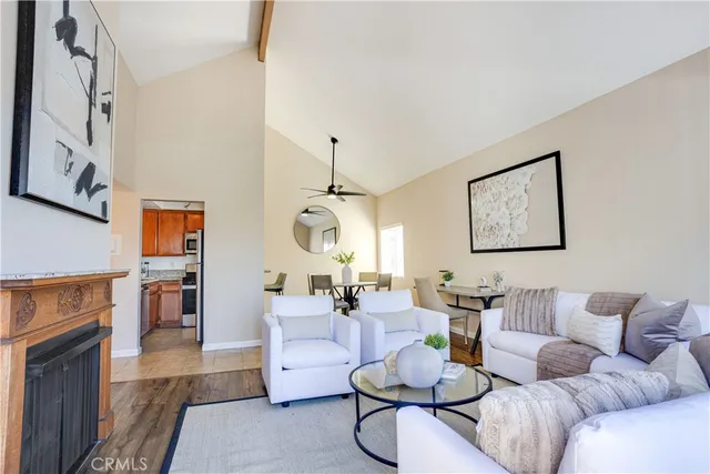 a living room with furniture a fireplace and a flat screen tv