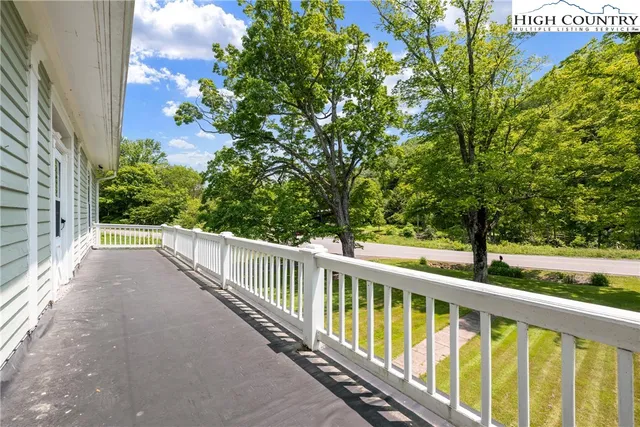 a view of a balcony with trees