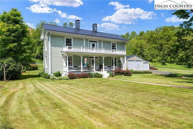 a front view of a house with a yard table and chairs
