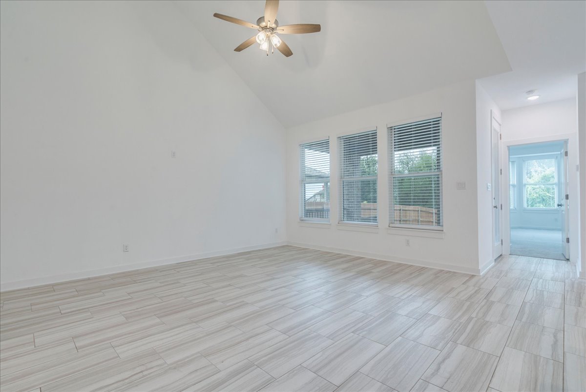 8008 Prairie Rye Drive Lago Vista, TX 78645 - Photo 19 of 40 Spacious interior featuring a vaulted ceiling with a ceiling fan