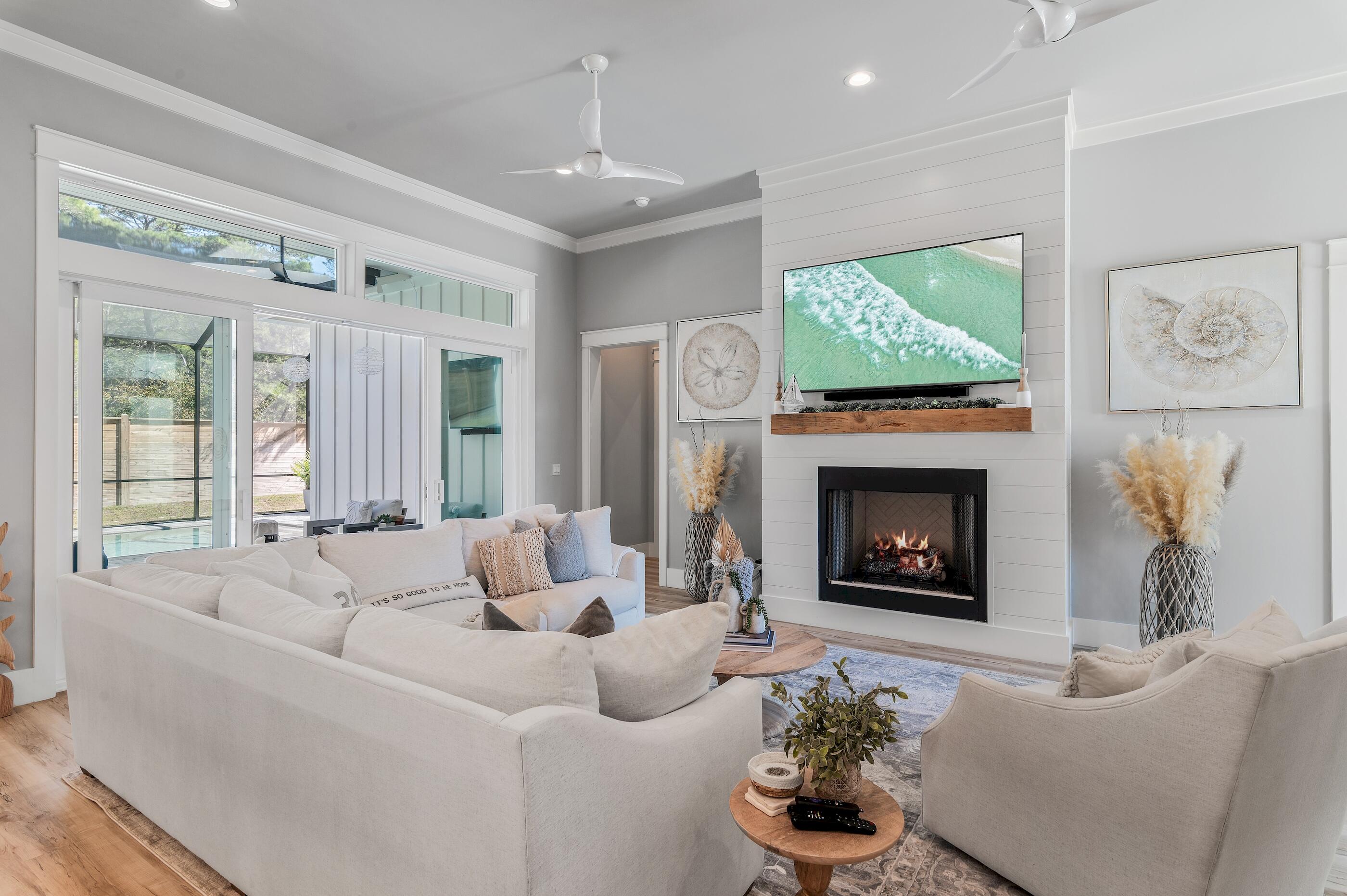 88 Beth Lane Santa Rosa Beach, FL 32459 - Photo 18 of 79 a living room with furniture a fireplace and a flat screen tv