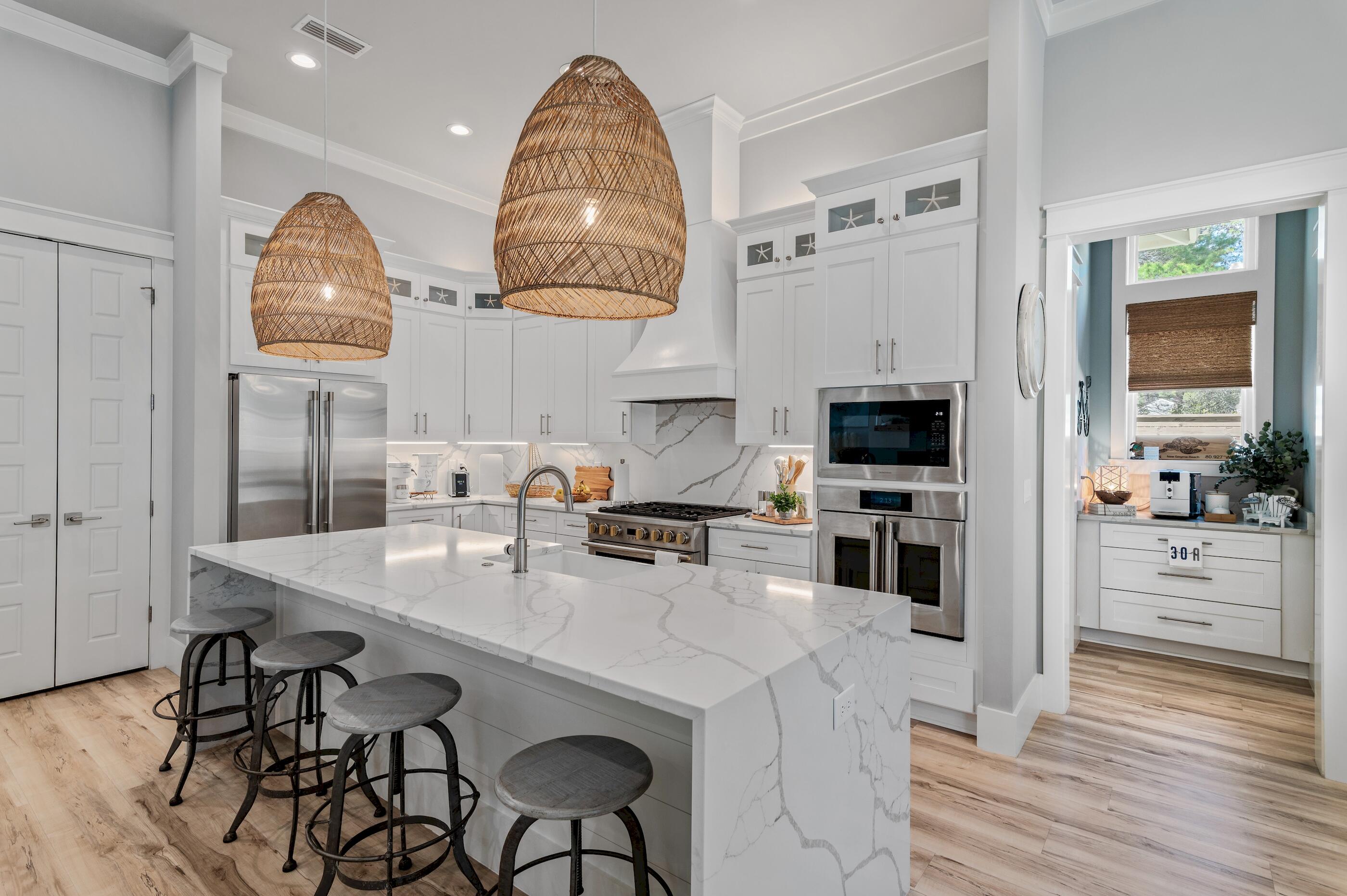 88 Beth Lane Santa Rosa Beach, FL 32459 - Photo 22 of 79 a kitchen with stainless steel appliances a table chairs and wooden floor