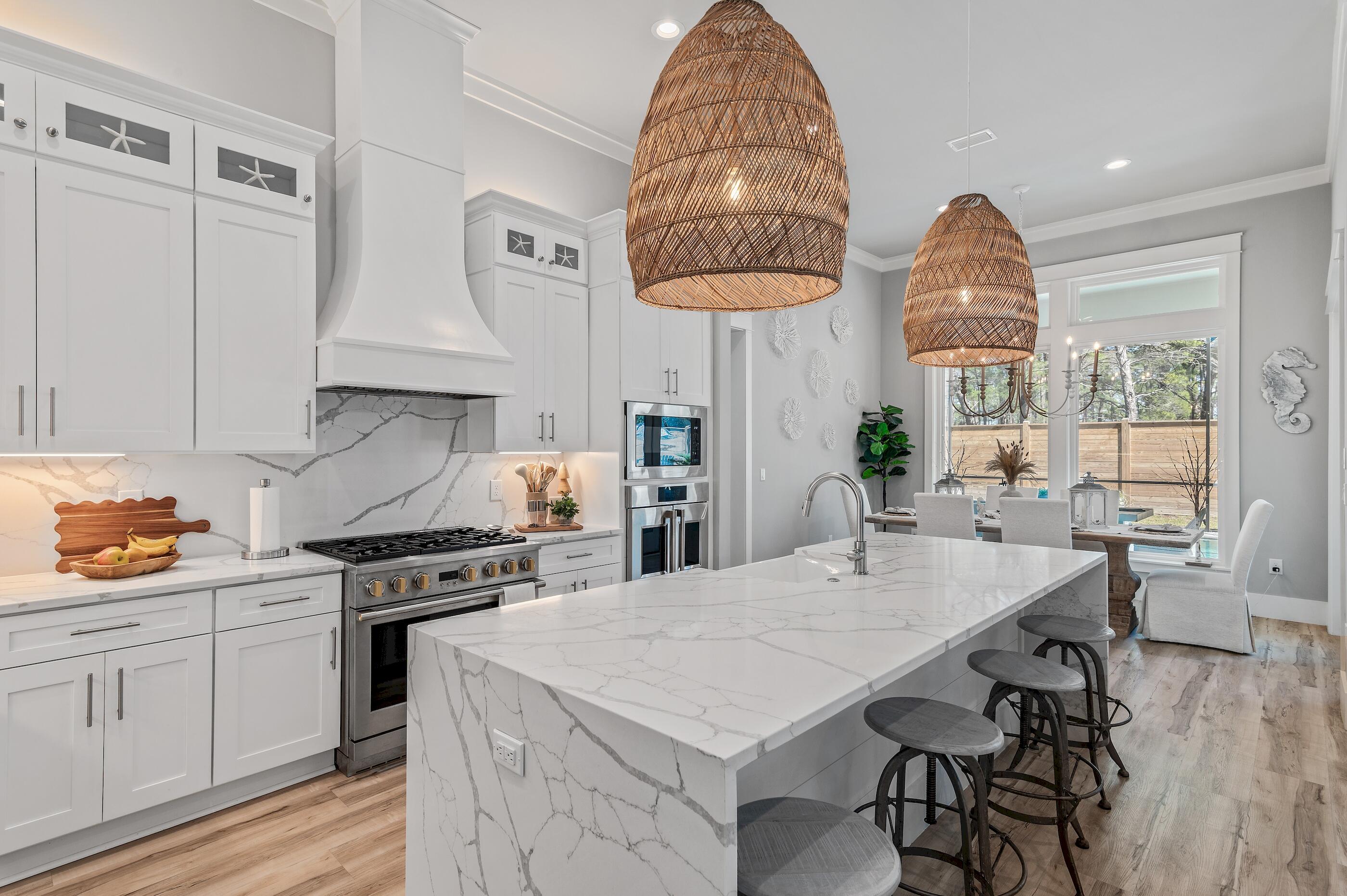 88 Beth Lane Santa Rosa Beach, FL 32459 - Photo 23 of 79 a kitchen with stainless steel appliances a stove a chimney a sink and cabinets