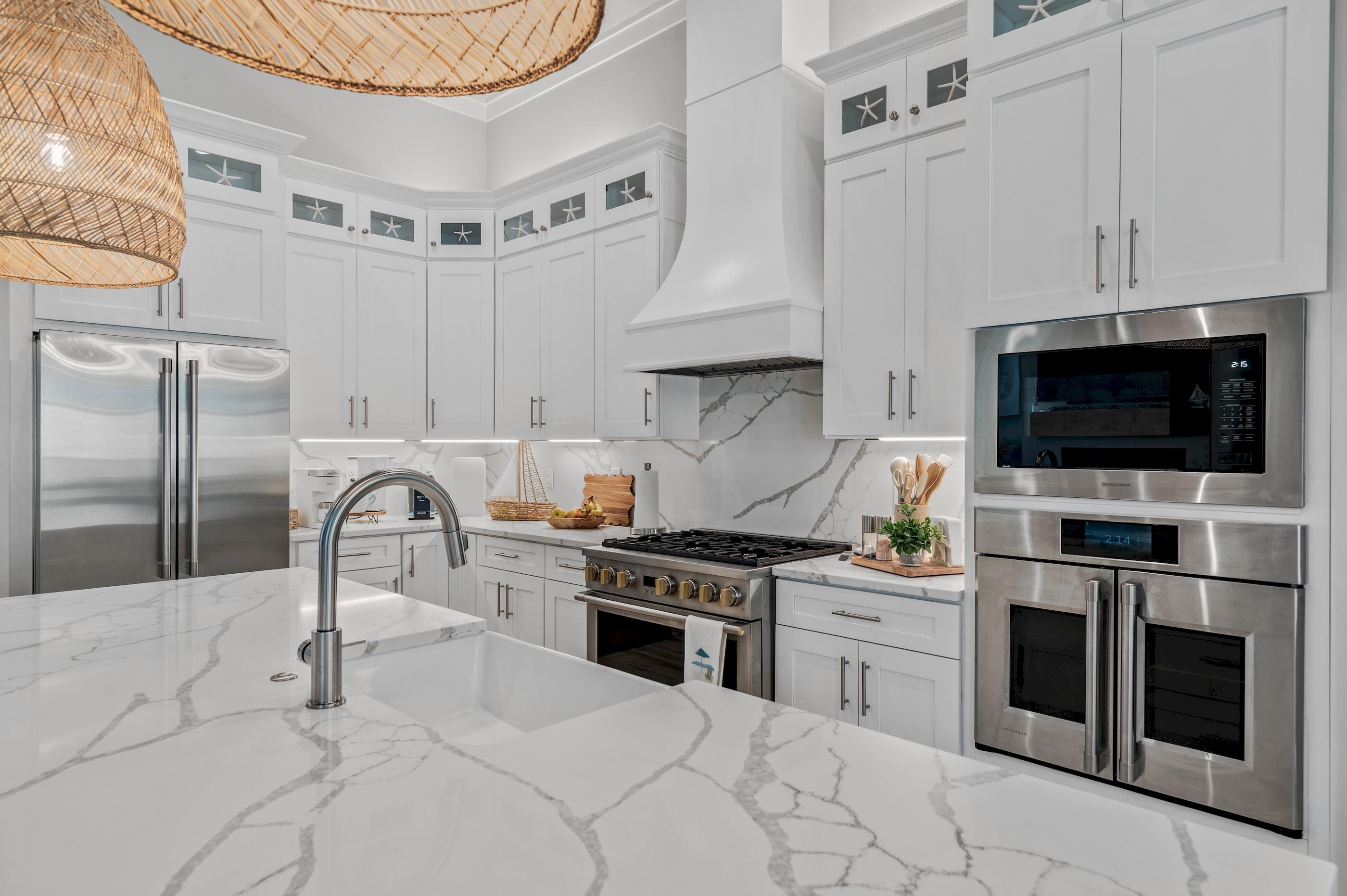 88 Beth Lane Santa Rosa Beach, FL 32459 - Photo 25 of 79 a kitchen with stainless steel appliances granite countertop a stove a sink dishwasher and a microwave oven with white cabinets
