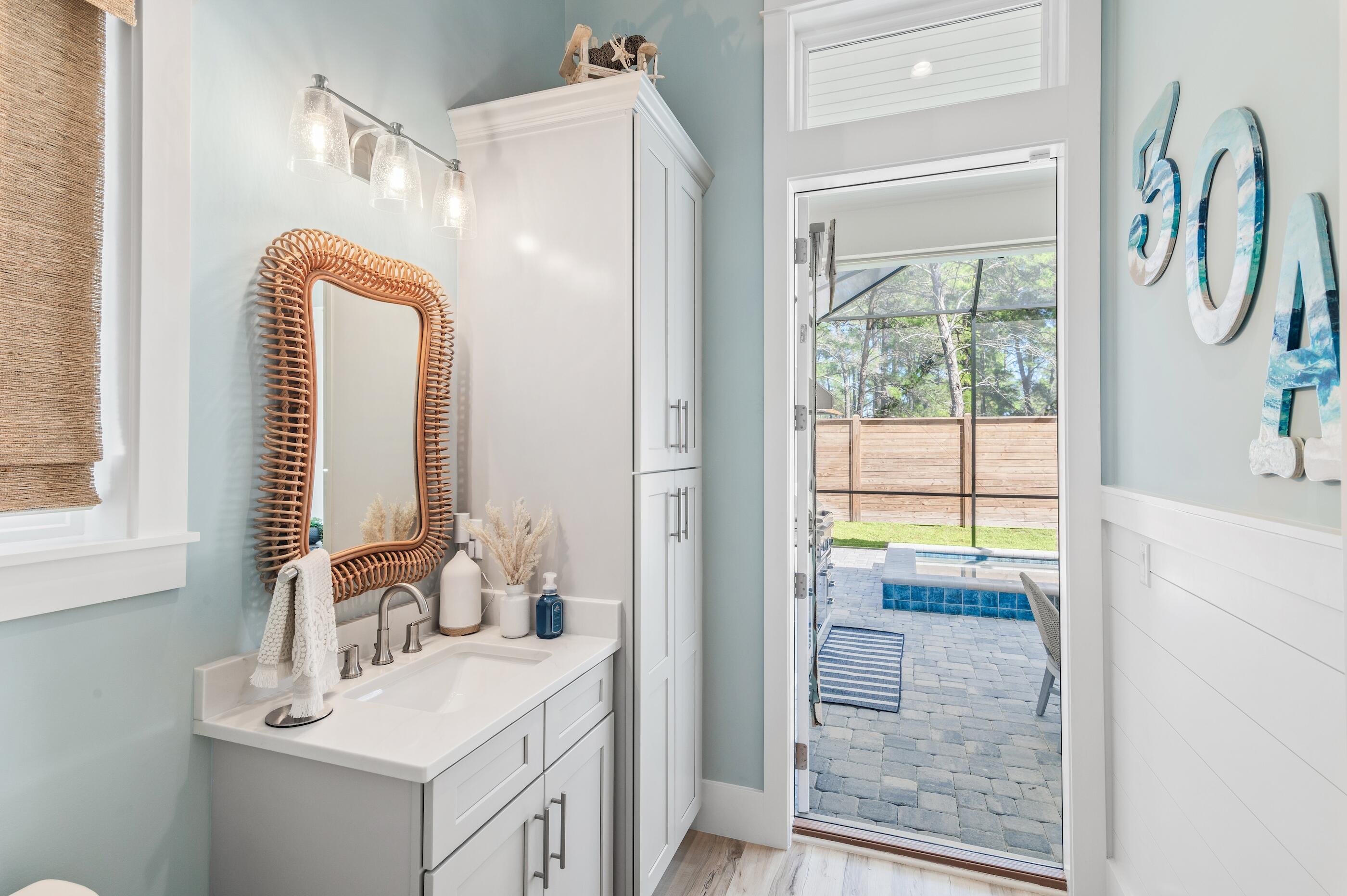 88 Beth Lane Santa Rosa Beach, FL 32459 - Photo 34 of 79 a bathroom with a sink a mirror and a window