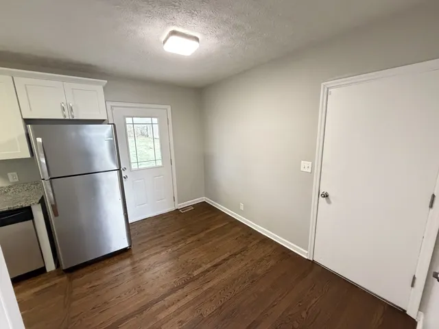 a kitchen with stainless steel appliances a refrigerator a sink a stove a microwave and cabinets