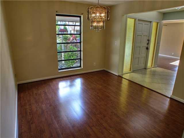 1400 Southwest 2nd Street Boca Raton, FL 33486 - Photo 7 of 9 an empty room with wooden floor and windows