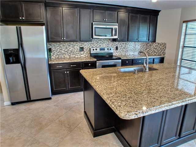 1400 Southwest 2nd Street Boca Raton, FL 33486 - Photo 8 of 9 a kitchen with a sink refrigerator and microwave